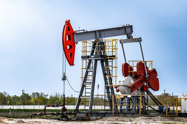 Extraction of crude oil in oilfield. Oil drilling rig pumps oil. Petroleum industry, oil and economic crisis. Fossil resources, ecological issues.