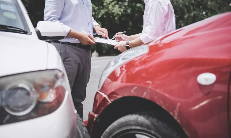 Insurance Agent examine Damaged Car and customer filing signature on Report Claim Form process after accident, Traffic Accident and insurance concept.