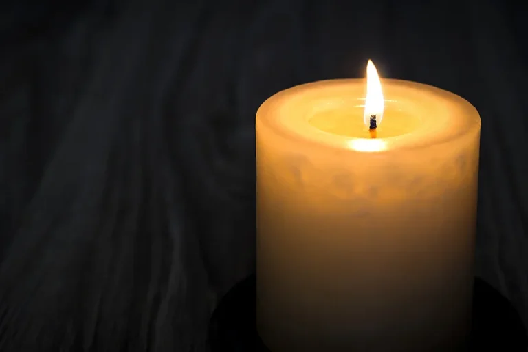 Candle on a wooden table. Death. Sympathy.