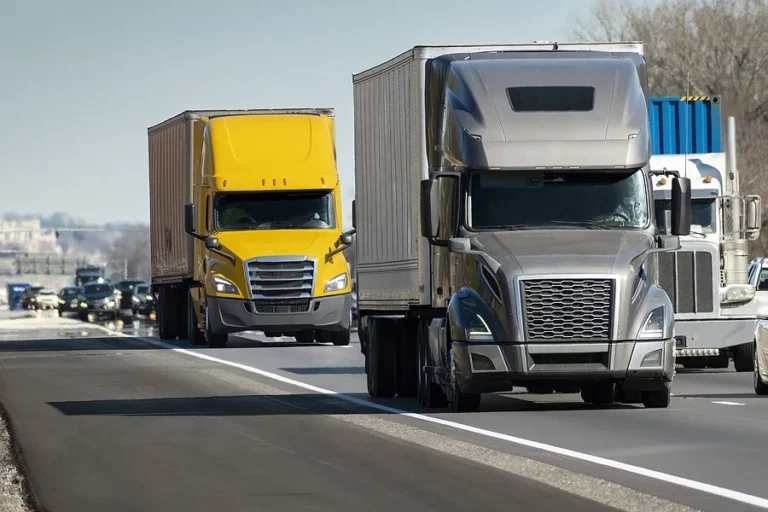 Horizontal shot of a heavy semi trucks convoy on the interstate.