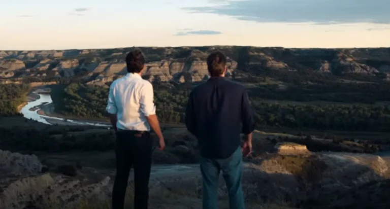 Bill sand and Rick sand standing at a river