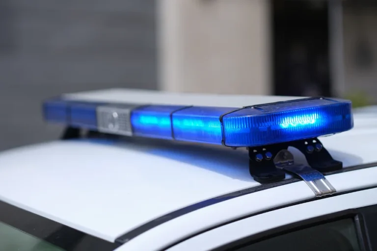 Closeup of blue lights on roof of police car. Flashing beacons of police car and arrest of criminal