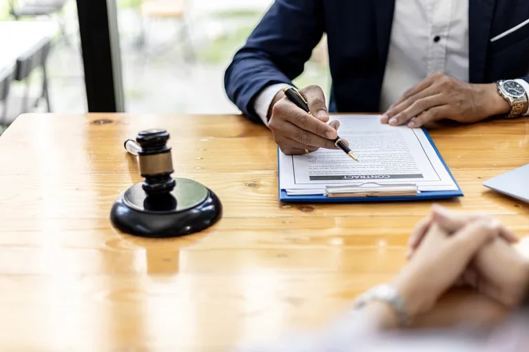 Lawyer and client shake hands, sign a lawsuit for the client, in which the client has filed a lawsuit against an employee of a company that commits fraud. The concept of litigation counseling.