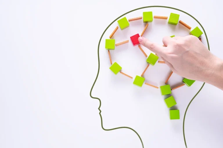 Brain damage concept. Brain disorder symbol. Head with colourful shapes of abstract brain. Human brain is made of multi-colored wooden blocks on white background.