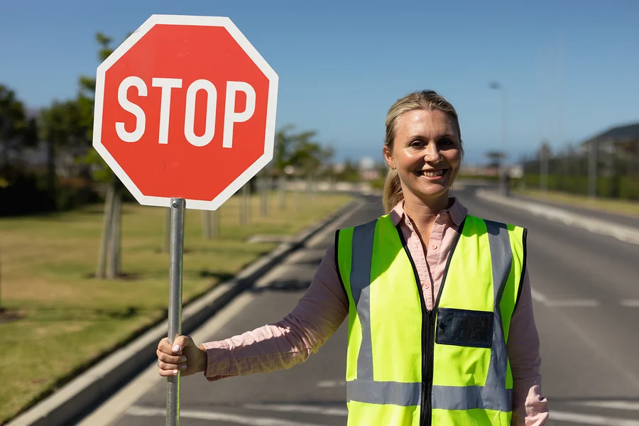 Portrait of a blonde Caucasian woman wearing a high visibility