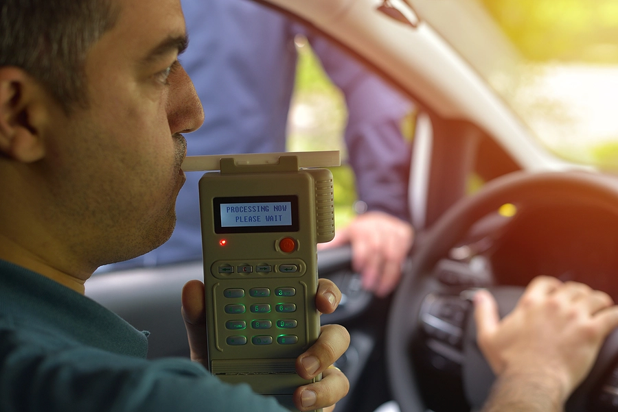 fargo driver taking a breathalyzer test during his first DUI arrest